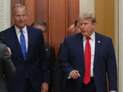 President Donald Trump walks with Senate Majority Leader John Thune, R-S.D., on Capitol Hi