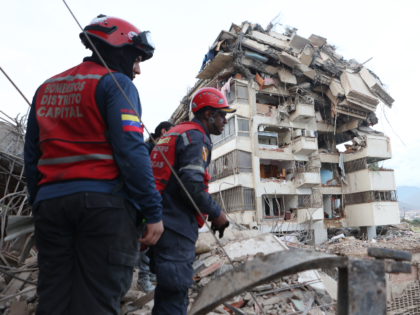 Rescue workers search through the rubble after an earthquake in La Guaira, Venezuela, Thur