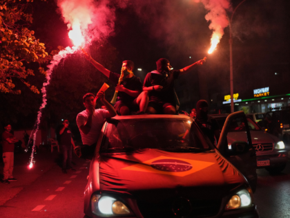 Supporters of Brazil's national soccer team celebrate after Brazil defeated Japan in