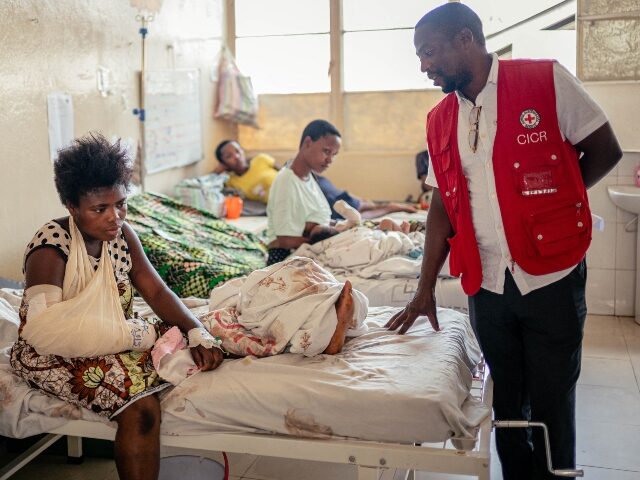 An International Committee of the Red Cross (ICRC) staff member speaks with Germaine Bauma