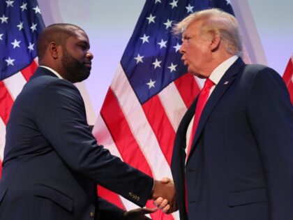 Rep. Byron Donalds (R-FL) shakes hands with former U.S. President Donald Trump during the