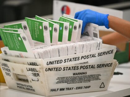 An election worker processes mail-in ballots at the Los Angeles County Ballot Processing C