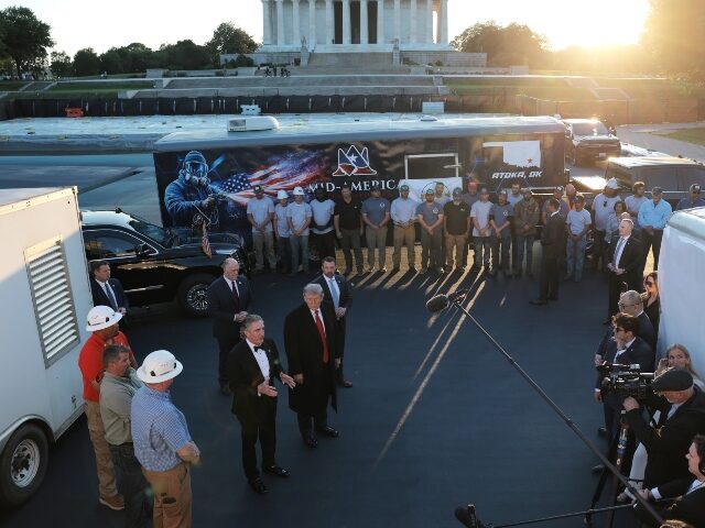 U.S. Secretary of the Interior Doug Burgum speaks, with U.S. President Donald Trump lookin