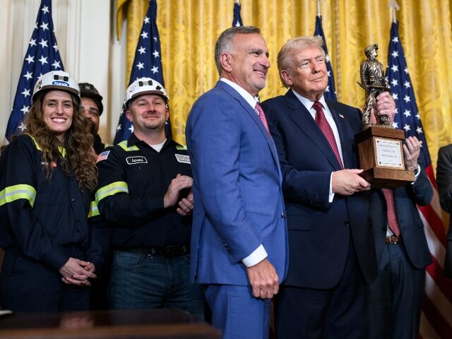 President and CEO of Peabody Energy Jim Grech presents an award to President Donald Trump