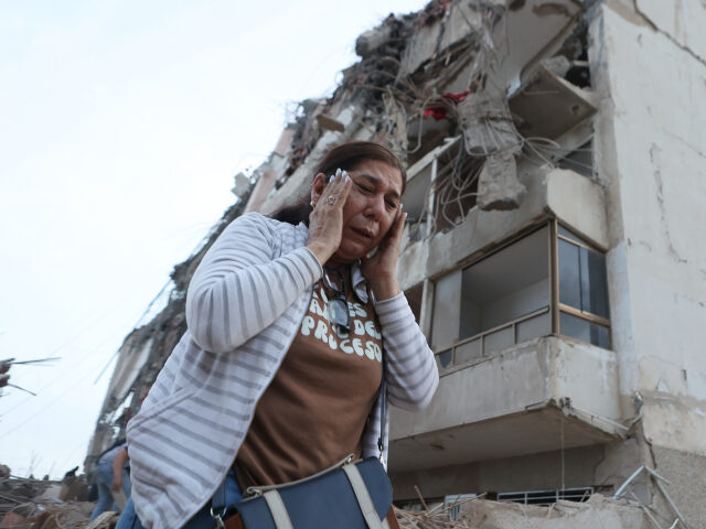 Earthquakes in Venezuela A woman walks past a building damaged during an earthquake in La Guaira, Venezuela, Thursd