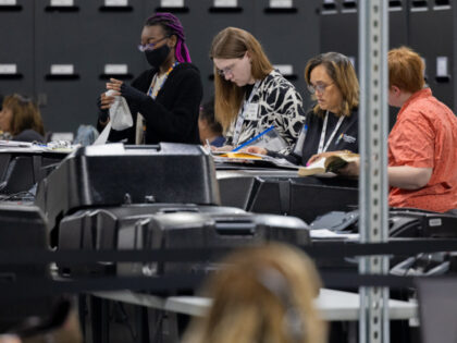 Election workers tabulate results of early voting and absentee ballots as citizens cast th