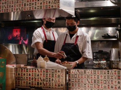 Chefs prepare takeout dinner orders inside the kitchen of Ho Lee Fook restaurant, closed t