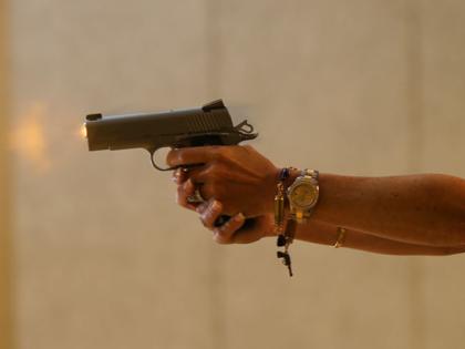 BOCA RATON, FL - OCTOBER 21: Susan Kushlin shoots a pistol while wearing one of the bracel