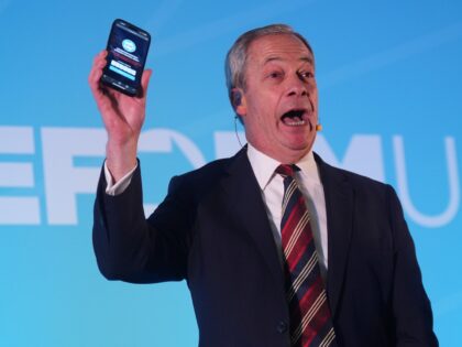 Reform UK leader Nigel Farage holding a phone displaying the number of Reform UK party mem