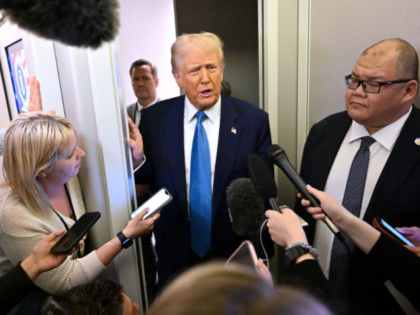 US President Donald Trump speaks with journalist, alongside White House Communications Dir