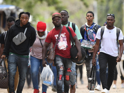 Cuban and Haitian migrants en route to the United States leave the Migrant Care Center aft