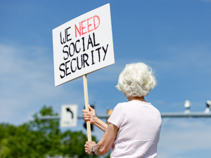 WOODLAWN, MD - MAY 20: Lynn McKerral holds a sign in support of Social Security Administra