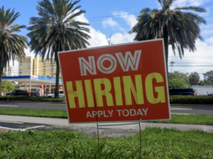 MIAMI, FLORIDA - OCTOBER 03: A 'Now Hiring' sign is posted outside of a business