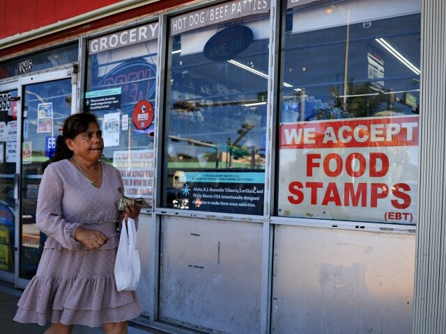  A 'We Accept Food Stamps' sign hangs in the window
