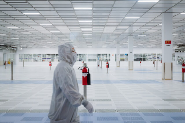 Ribbon Cutting Ceremony At Texas Instruments Semiconductor Wafer Plant A worker walks through a clean room inside the Texas Instruments (TI) semiconductor wafer