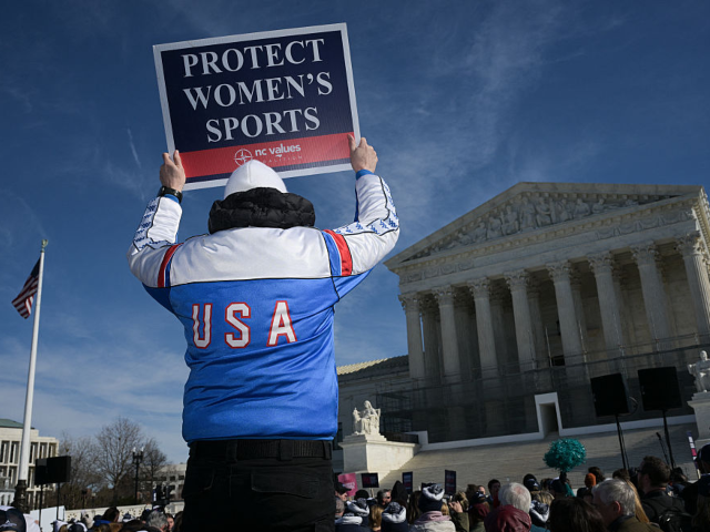 TOPSHOT - A man holds up a sign reading "Protect women's sports" as he demonstrates outsid