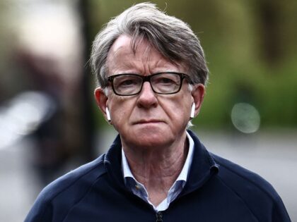 Former UK ambassador to the United States, Peter Mandelson, is pictured as he walks his do