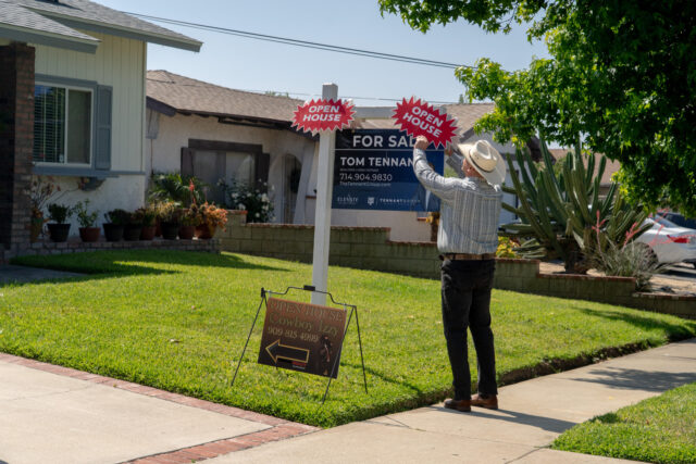 A real estate agent sets up for an open house in Rancho Cucamonga, California, US, on Satu