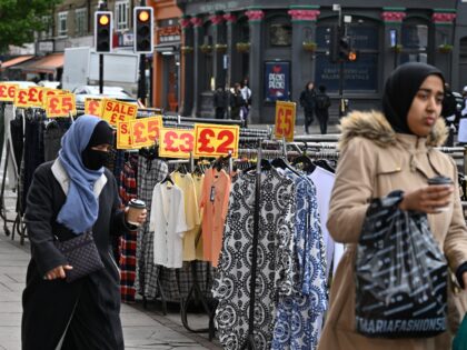 LONDON, ENGLAND - MAY 11: A general view a women wearing a Niqab and Hijab walk past sale