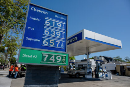 A sign displays the prices of unleaded gasoline and diesel fuel at a Chevron gas station i