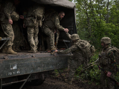 UNSPECIFIED, UKRAINE - MAY 31: Ukrainian servicemen board a military truck after attending