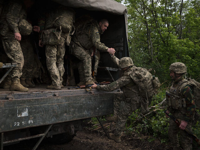 UNSPECIFIED, UKRAINE - MAY 31: Ukrainian servicemen board a military truck after attending