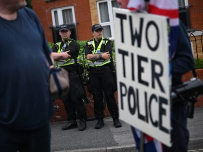 SOUTHAMPTON, ENGLAND - JUNE 07: A protestor holds a sign stating "two tier police" during