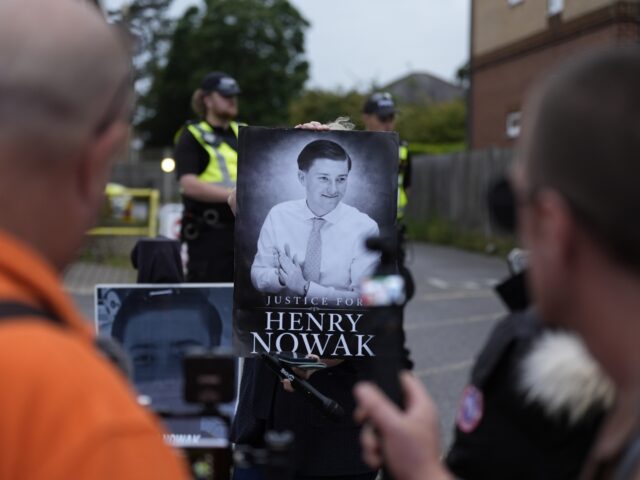 A protester holds an image of Henry Nowak outside Portswood Police station in Southampton,