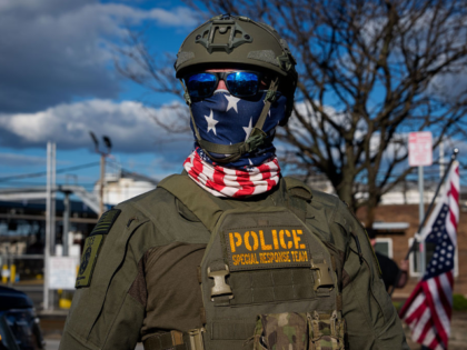 NEWARK, NEW JERSEY - JUNE 7: Immigration and Customs Enforcement (ICE) agents face off wit