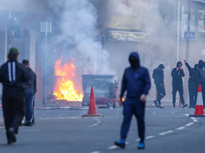 TOPSHOT - A building is set alight in the Sandy Row area of Belfast city centre, Northern