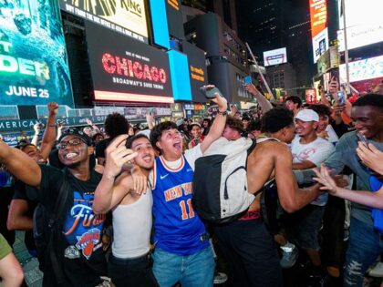 NEW YORK, NEW YORK - JUNE 10: New York Knicks fans celebrate in Times Square as they win G