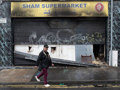 A pedestrian walks past the The Sham supermarket on Blondin Street, which was attacked dur
