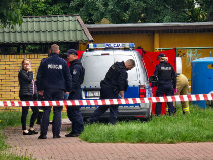 TOPSHOT - Police work at a crime scene covered with a tent (back R) in Biala Podlaska, eas