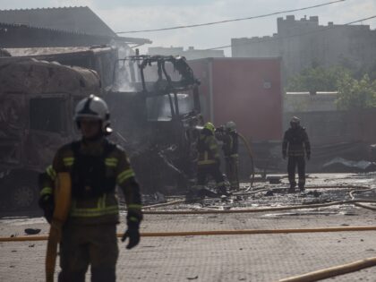 SUMY, UKRAINE - JUNE 17: Firefighters extinguish a fire on burnt-out trucks in the parking