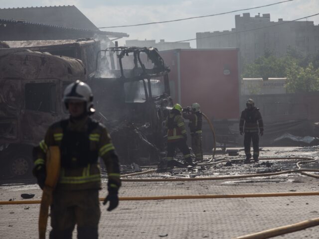 SUMY, UKRAINE - JUNE 17: Firefighters extinguish a fire on burnt-out trucks in the parking