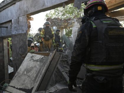 EDITORS NOTE: Graphic content / Ukrainian rescuers work at the site of an airstrike in Kha