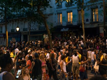 Large night crowd in a Paris street during Fete de la Musique in Paris, Ile-de-France, Fra