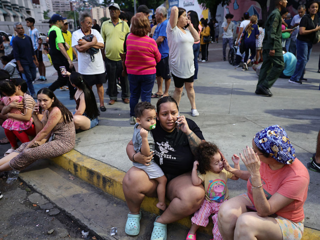 CARACAS, VENEZUELA - JUNE 24: Evacuated people speak by phone waiting at Parque Central ur