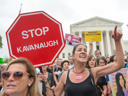 GettyImages1046729452 Demonstrators shout as they protest against the appointment of Supreme Court nominee Brett