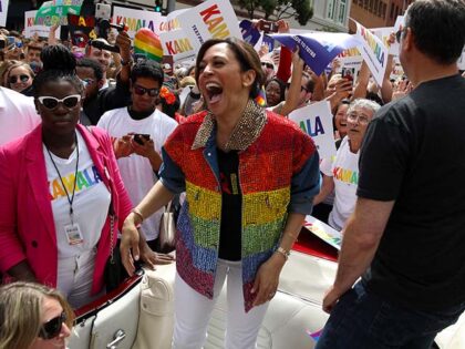 Democratic presidential candidate U.S. Sen. Kamala Harris (D-CA) laughs as she rides in a