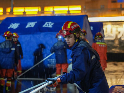 Rescuers set up tents at a temporary relocation site inside a culture and sports center in