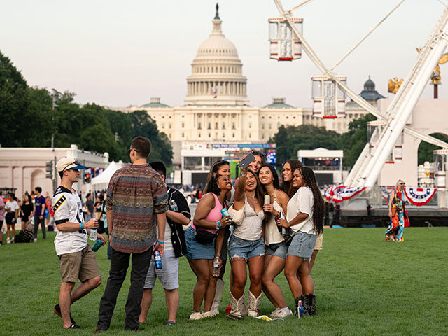 Visitors pose for a photo on the first day of the 