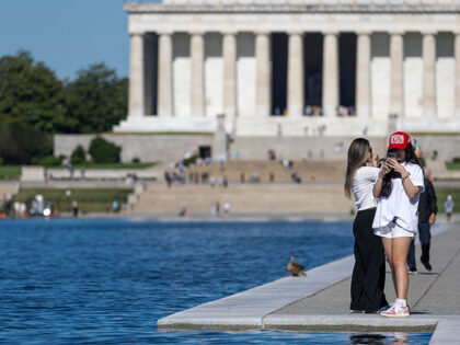 Visitors walk along the Lincoln Memorial Reflecting Pool on the National Mall on June 24,