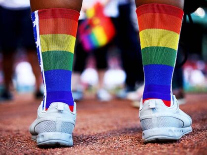 A fan wears rainbow colored socks for Pride Night before a game between the Boston Red Sox