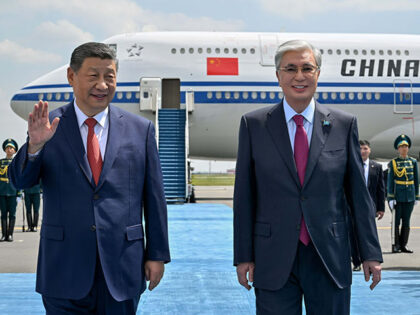 Chinese President Xi Jinping, left, walks upon his arrival with Kazakh President Kassym-Jo