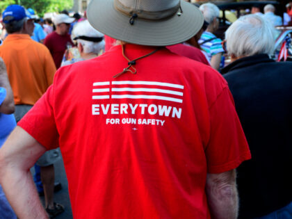 A man wears a 'Moms Demand Action for Gun Sense in America' T-shirt at a Fourth
