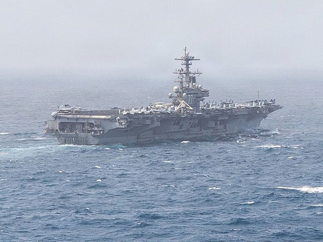 USS George H.W. Bush (CVN 77) sails in the Arabian Sea. Two aircraft carriers continue to