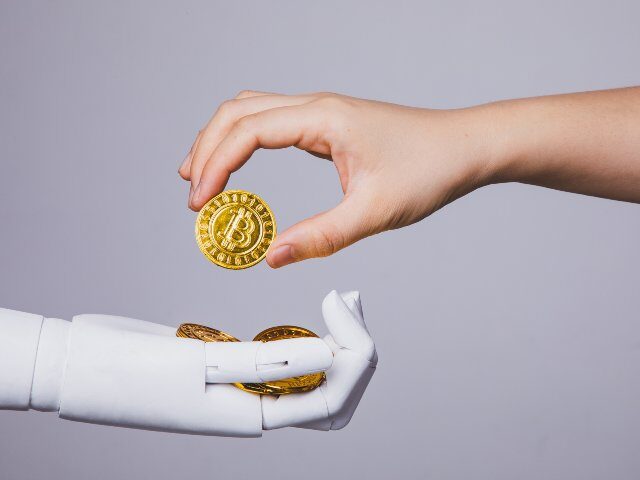 Human handing bitcoin to robot