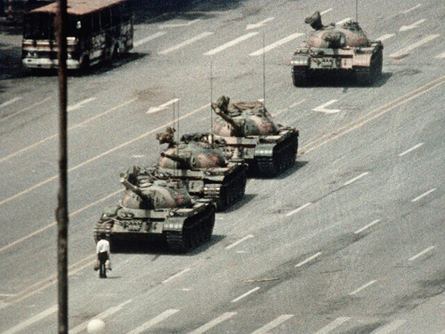 A Beijing demonstrator blocks the path of a tank convoy along the Avenue of Eternal Peace