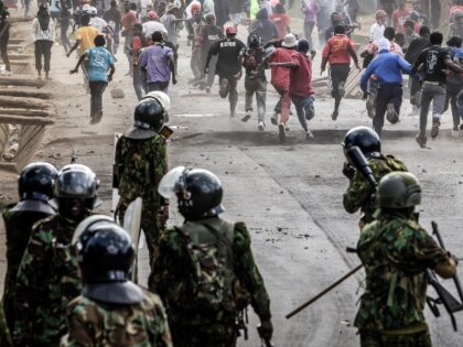 Demonstrators run for cover during clashes with Kenya police officers at a demonstration a